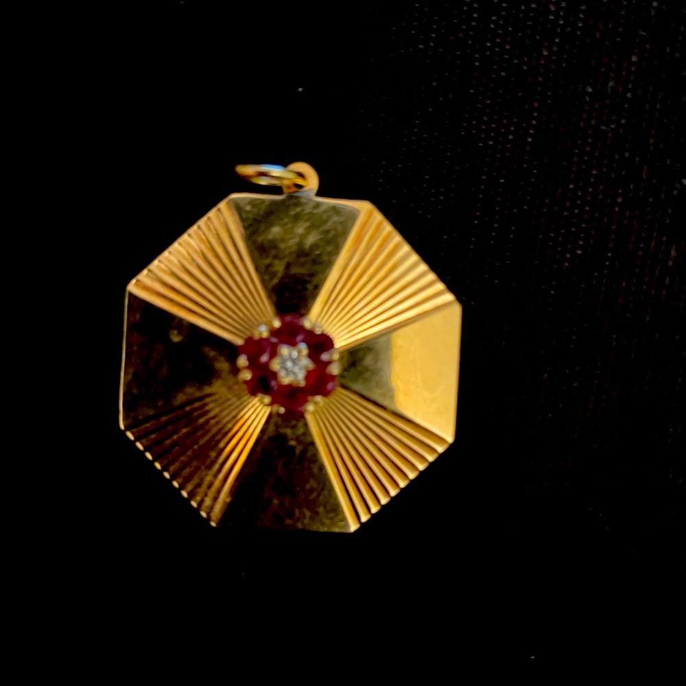 Tiffany  & Company signed 18 K charm. Inserts of diamonds and rubies. Tiffany